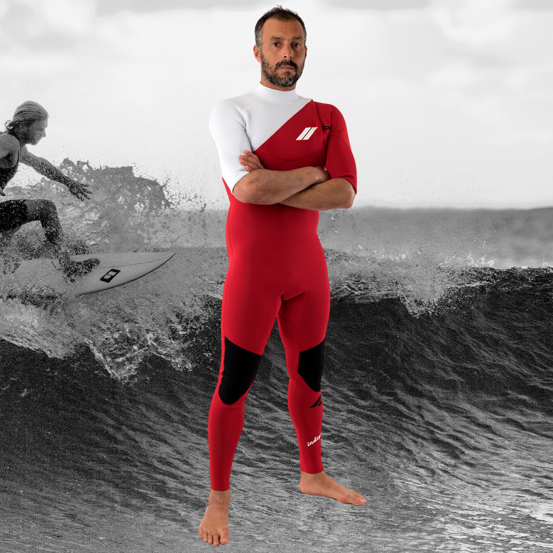 Surfer wearing JANGA INDIGENT SHORT SLEEVE RED 2mm wetsuit in the water