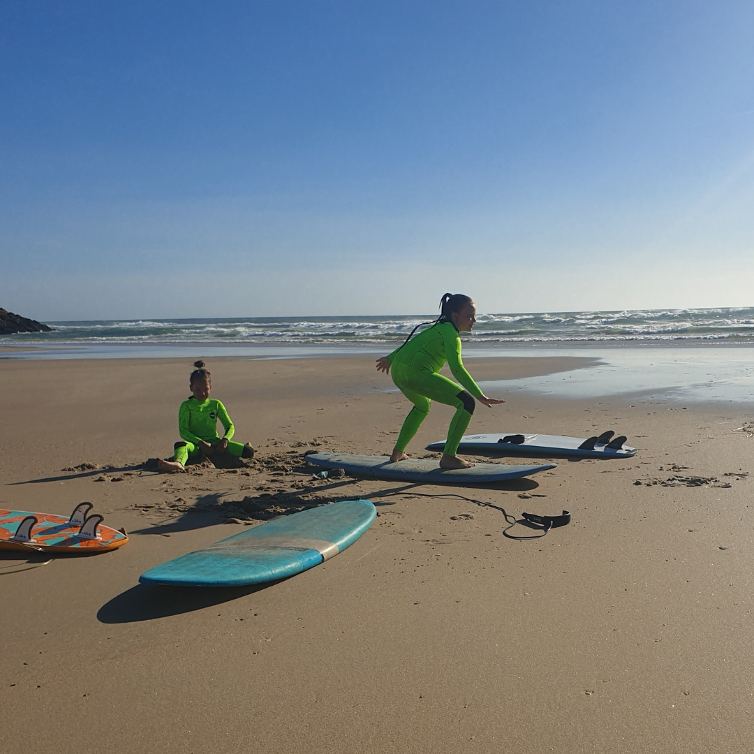 Kids surfing in JANGA Fineline 4/3mm bright green wetsuit
