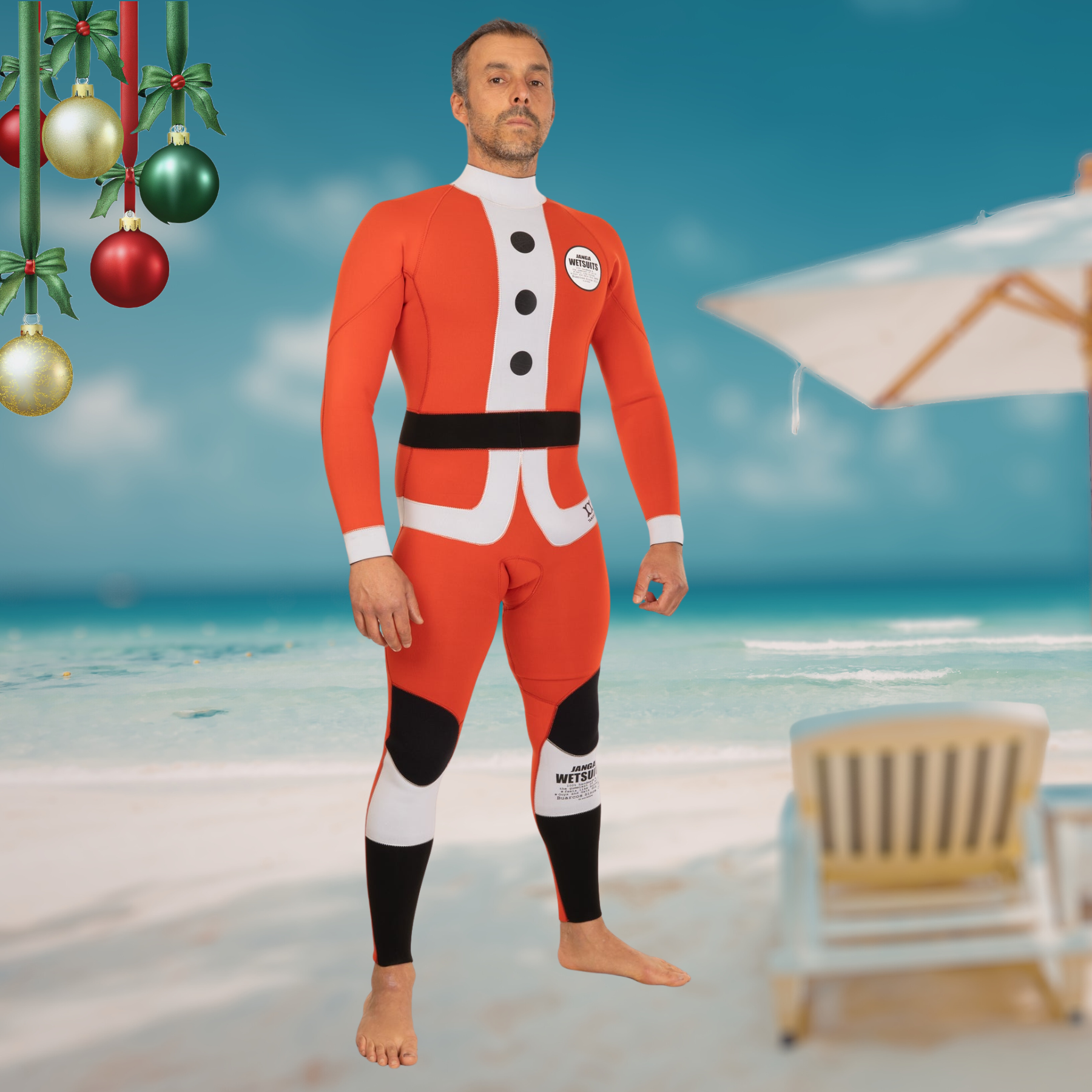 Man wearing a red and black wetsuit on a beach with Christmas decorations.